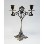 An Art Nouveau WMF Silver Plated candlestick with a decorative stylised floral design and pierced