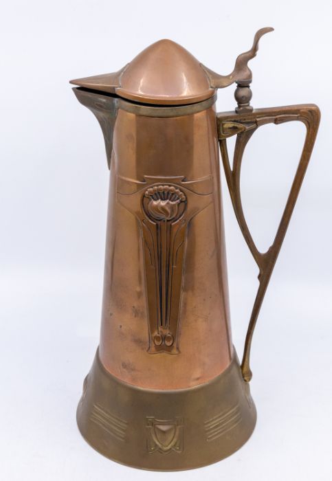 An Arts & Crafts large Jugendstil copper water jug with layered brass to rims and handle. An Art
