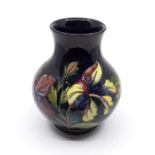 Moorcroft 'Hibiscus' pattern ovoid vase designed by Walter Moorcroft. Height approx 19cm. Marks to