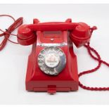 A 1950s Type 312 red Bakelite GPO telephone, circa 1950, impressed marks 164 - 50 to handset, with