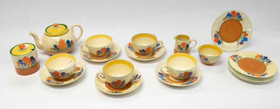 A Clarice Cliff Crocus tea set; a globe shaped teapot, milk jug, sugar basin, five cups and saucers,