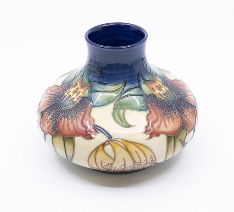 Moorcroft Pottery, a compressed baluster vase decorated in 'Anna Lily' pattern. Height approx 16.