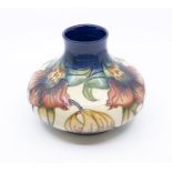 Moorcroft Pottery, a compressed baluster vase decorated in 'Anna Lily' pattern. Height approx 16.