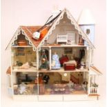 Dolls House: A mid to late-20th century three storey dolls house, furnished, with figures, open