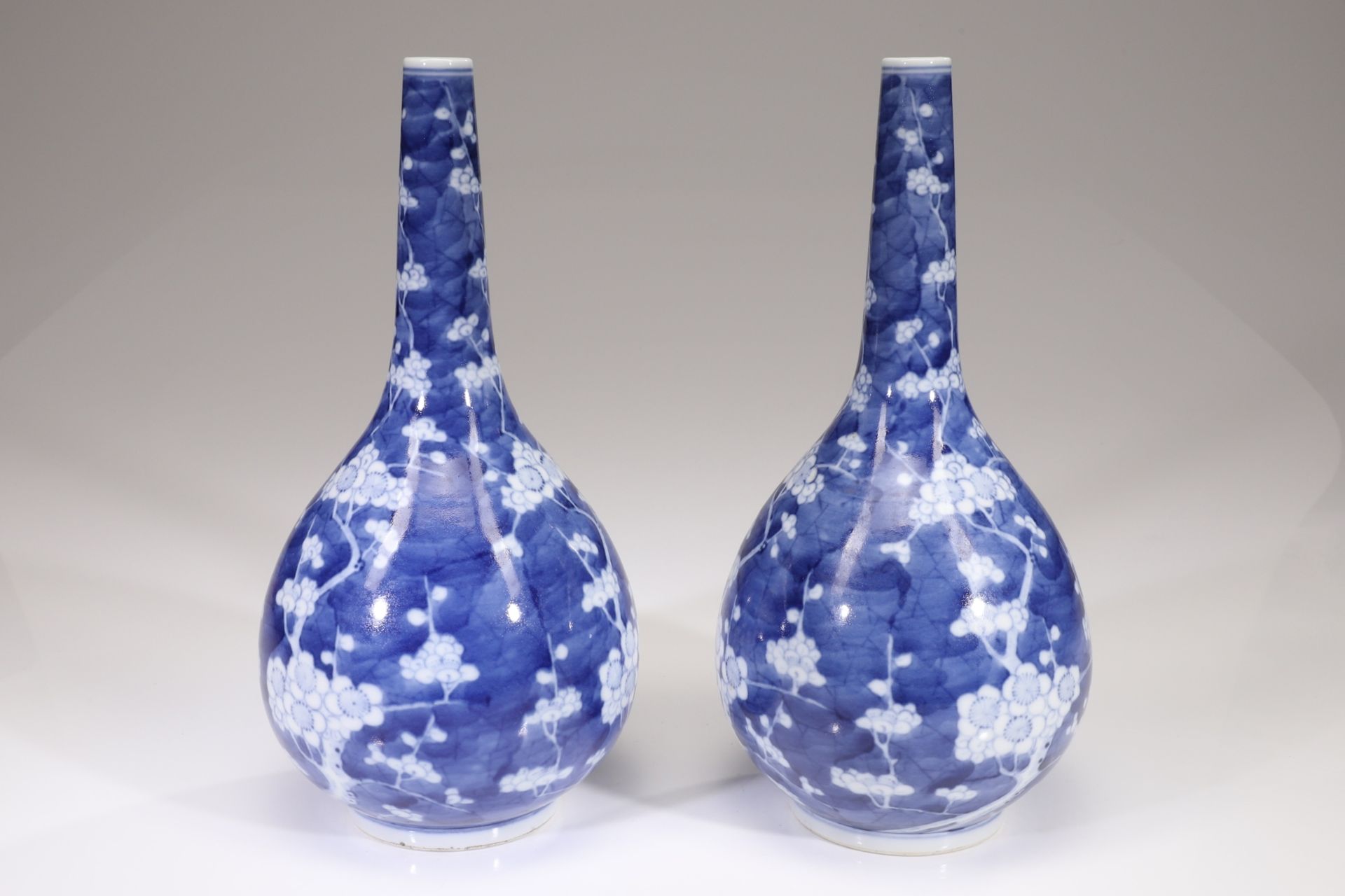 A PAIR OF BLUE AND WHITE 'PRUNUS AND CRACKED ICE' BOTTLE VASES