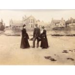 Photographs in a small album. Charming images of a town and coastal area with people and activities