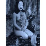 Jun Yoshida, photograph of a nude with mask in a garden. Studio stamped on reverse.