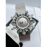 OMEGA WHITE GOLD COCKTAIL WATCH WITH DIAMONDS AND EMERALDS