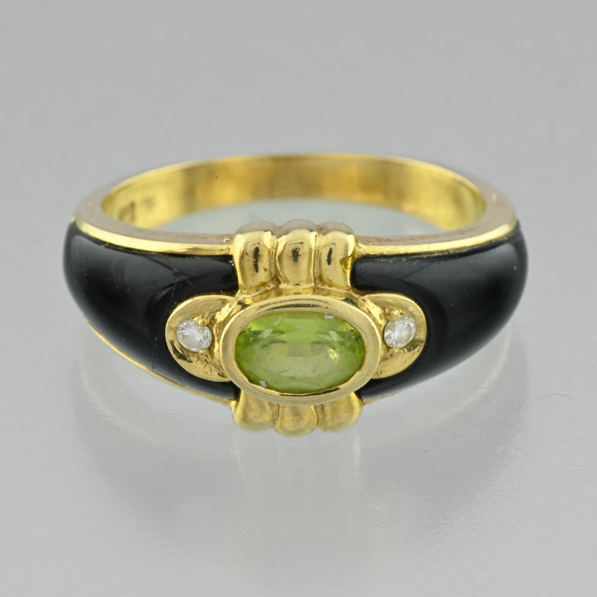 Black enamel and peridot ring In 18 Karat yellow gold, the body of the ring is covered on the
