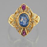 Ring In yellow gold 18 Karat, set with a sapphire of two rubies in a surround of small diamonds.