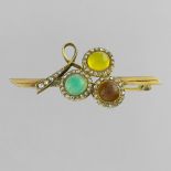 Tricolour brooch In yellow gold 14 Karat, set with three cabochons of coloured stones in a