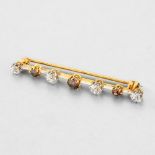 White and cognac diamond brooch In yellow and white 18-carat gold, set with three brilliant-cut