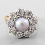 Ring pearl surrounded by diamonds In yellow and white 18-carat gold, set in the centre with a