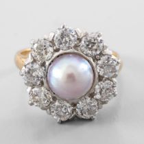Ring pearl surrounded by diamonds In yellow and white 18-carat gold, set in the centre with a