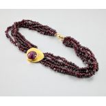 Modernist necklace. Necklace of four rows of irregular pearls in amethyst, decorated with a centre