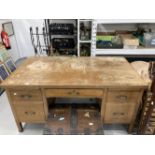 20th cent. Oak five drawer desk with two brushing slides on square legs terminating with brass caps,