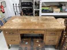 20th cent. Oak five drawer desk with two brushing slides on square legs terminating with brass caps,