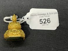 Jewellery: Yellow metal fob with shell decoration set with a carved bloodstone, tests as 18ct