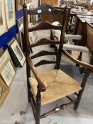 19th cent. Oak ladder back armchair with scroll arms, turned supports, on rounded legs with turned