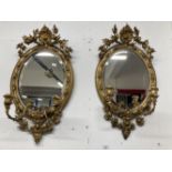18th cent. Oval gilt gesso on wood Girandole mirrors with bevelled plates. Some losses to the gilt