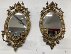 18th cent. Oval gilt gesso on wood Girandole mirrors with bevelled plates. Some losses to the gilt