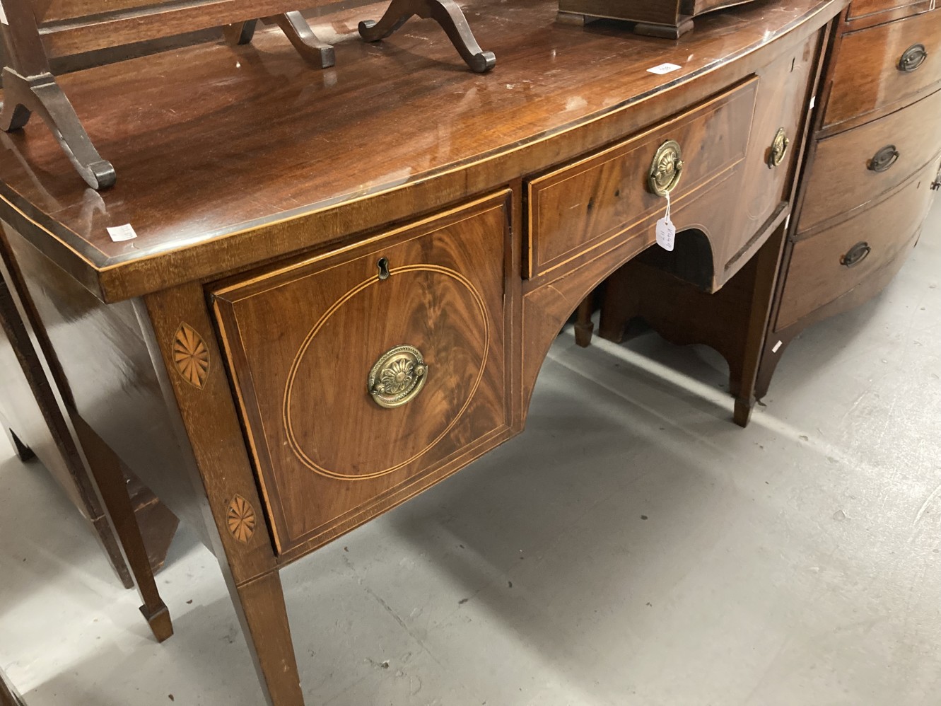 Georgian bow fronted mahogany cabinet with a single central drawer flanked by two deep cellarette