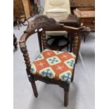 Early 20th cent. Carved oak corner chair with bobbin turned legs, upholstered carpet seat, the