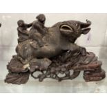 20th cent. Chinese hardwood carved water buffalo with two boys on its back, on stand. 1 horn A/F.