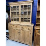 19th cent. Continental pine dresser/cabinet, the top with moulded cornice enclosed by two glazed