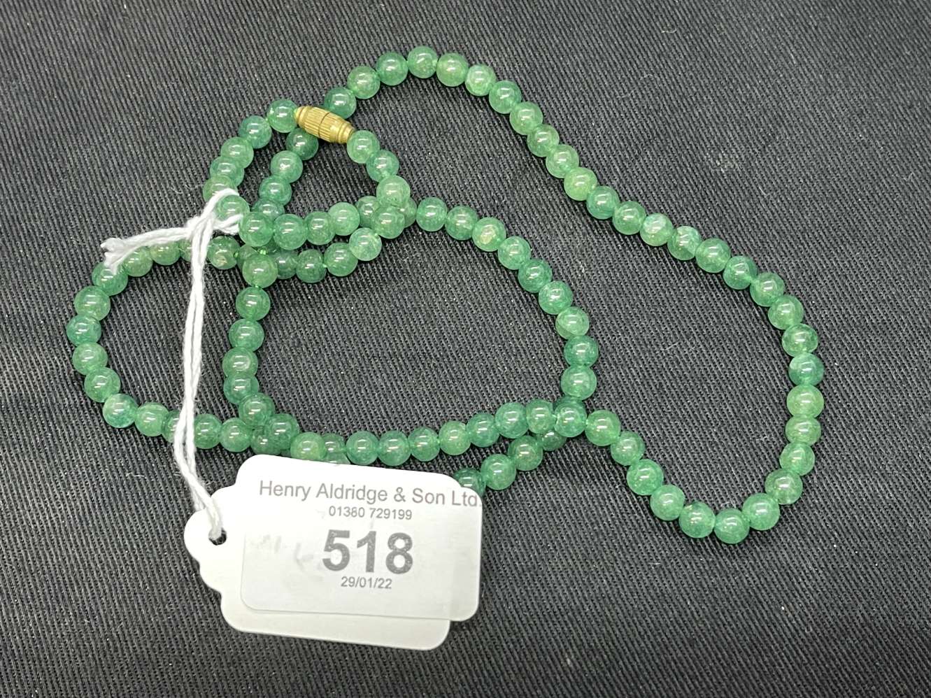 Jewellery: Necklet of (110) 5.5mm. to 6mm. Jade beads.