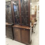 Early 20th cent. Mahogany two part bookcase, the thirteen pane glazed doors above two blind doors on