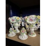 19th/20th cent. Saxe Porcelain vases each with handles above cherubs encrusted with flowers and