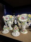 19th/20th cent. Saxe Porcelain vases each with handles above cherubs encrusted with flowers and