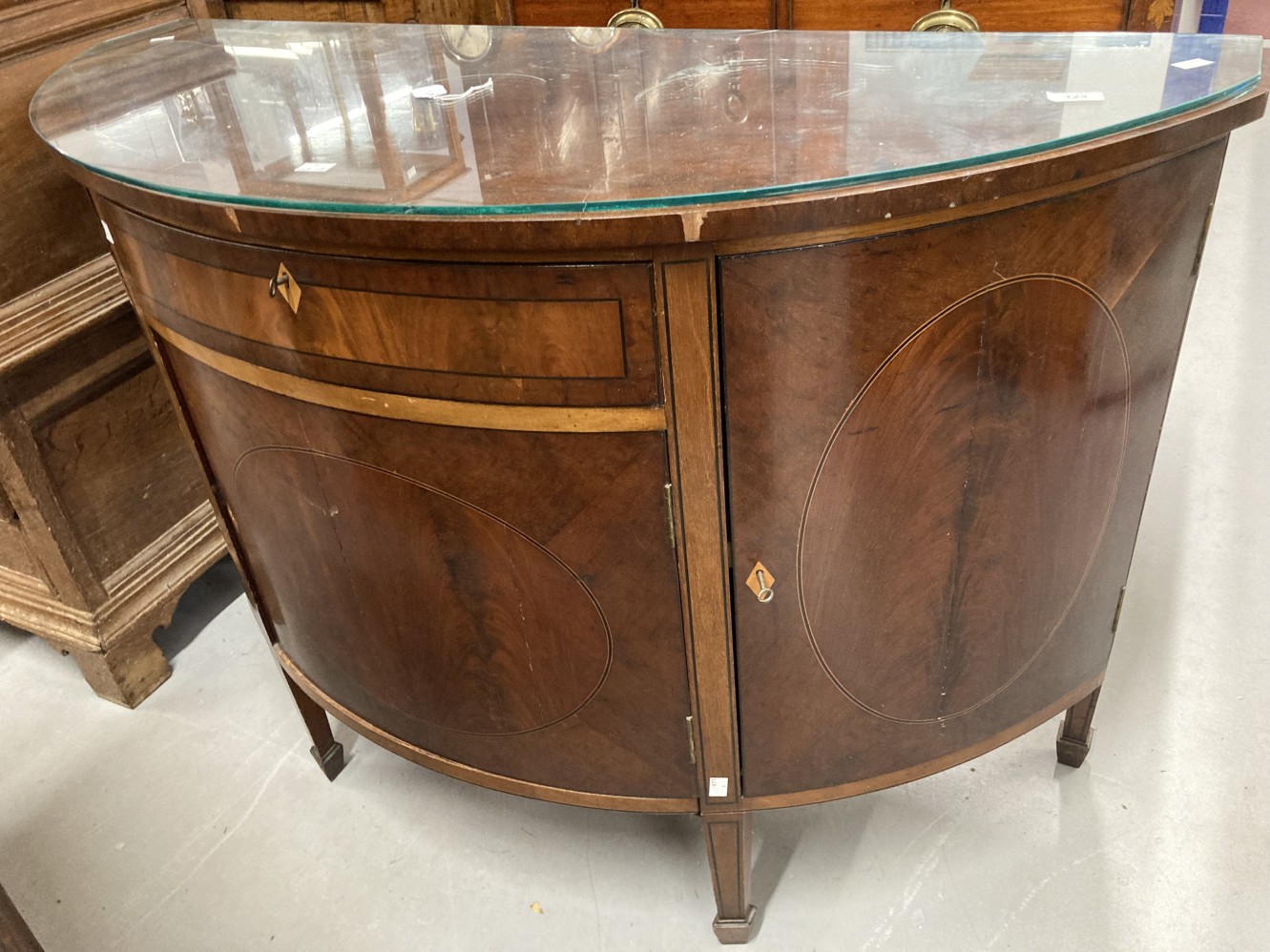 18th/19th cent. Hepplewhite style walnut and mahogany demi-lune cabinet with satinwood and