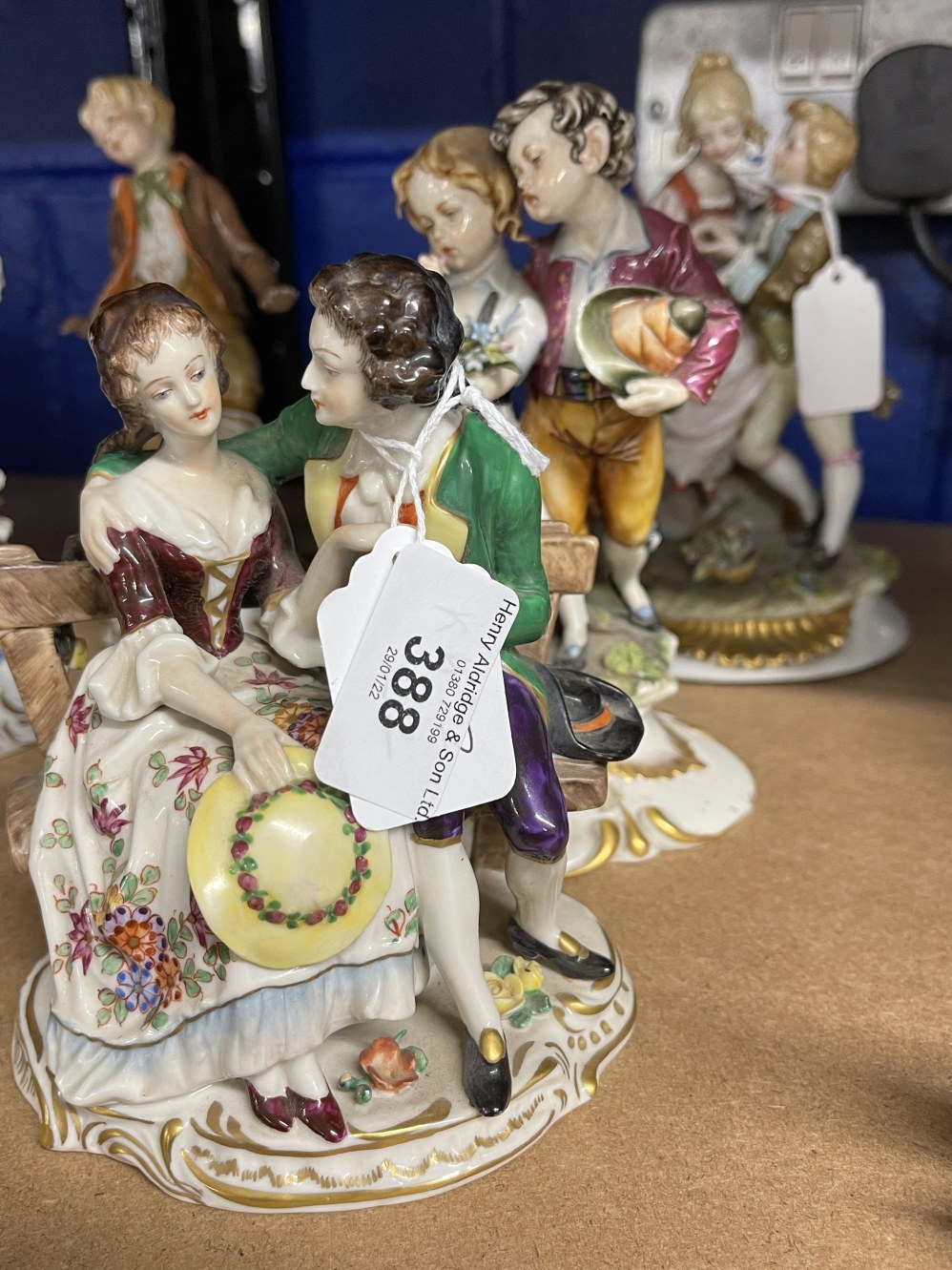 20th cent. Ceramics: Crown Naples pair of lovers by tree stump (A/F), lovers sitting on a bench, boy