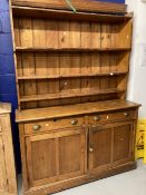 19th cent. Pine dresser the top with moulded cornice and three graduated shelves. The base with