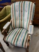 19th cent. Button back library armchair with scroll arms and turned legs on castors. 40ins. High.