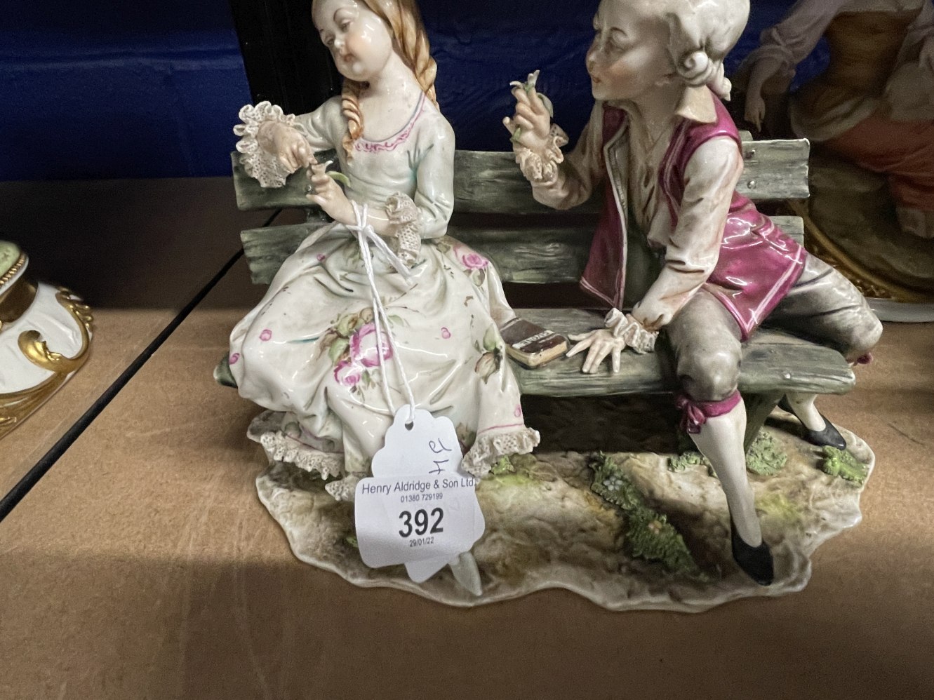 20th cent. Crown Naples lovers seated on a bench, N mark in underglaze blue.