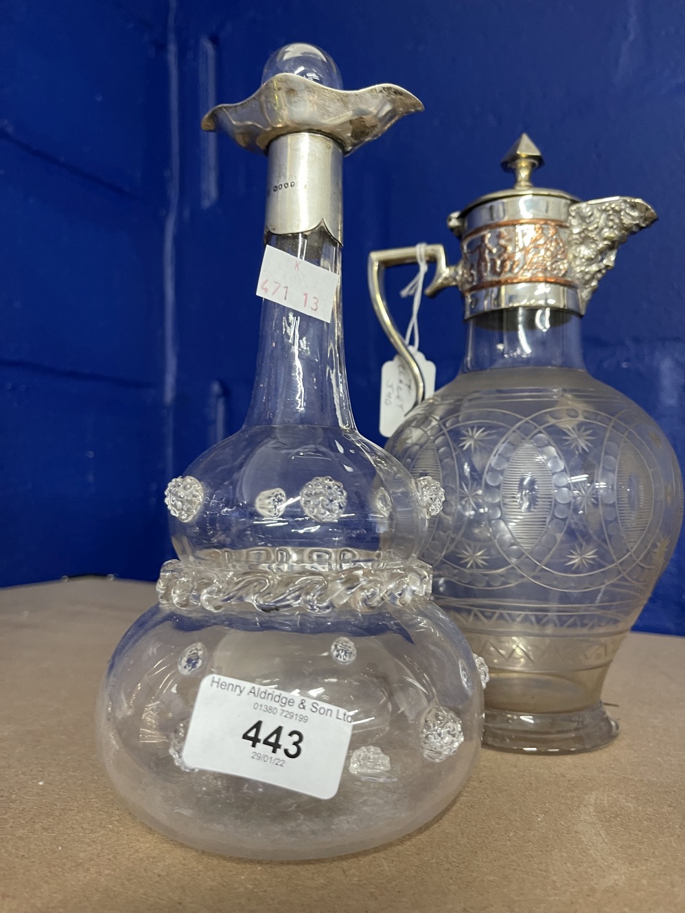 Glass and hallmarked silver collar port decanter with raised floral decoration on glass (glass