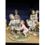 20th cent. Ceramics: Crown Naples mother and child, boy and girl with reading book, girl holding