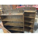 Arts & Crafts: A pair of oak five shelf bookcases with hearts carved into the top. 36ins. x 49ins. x
