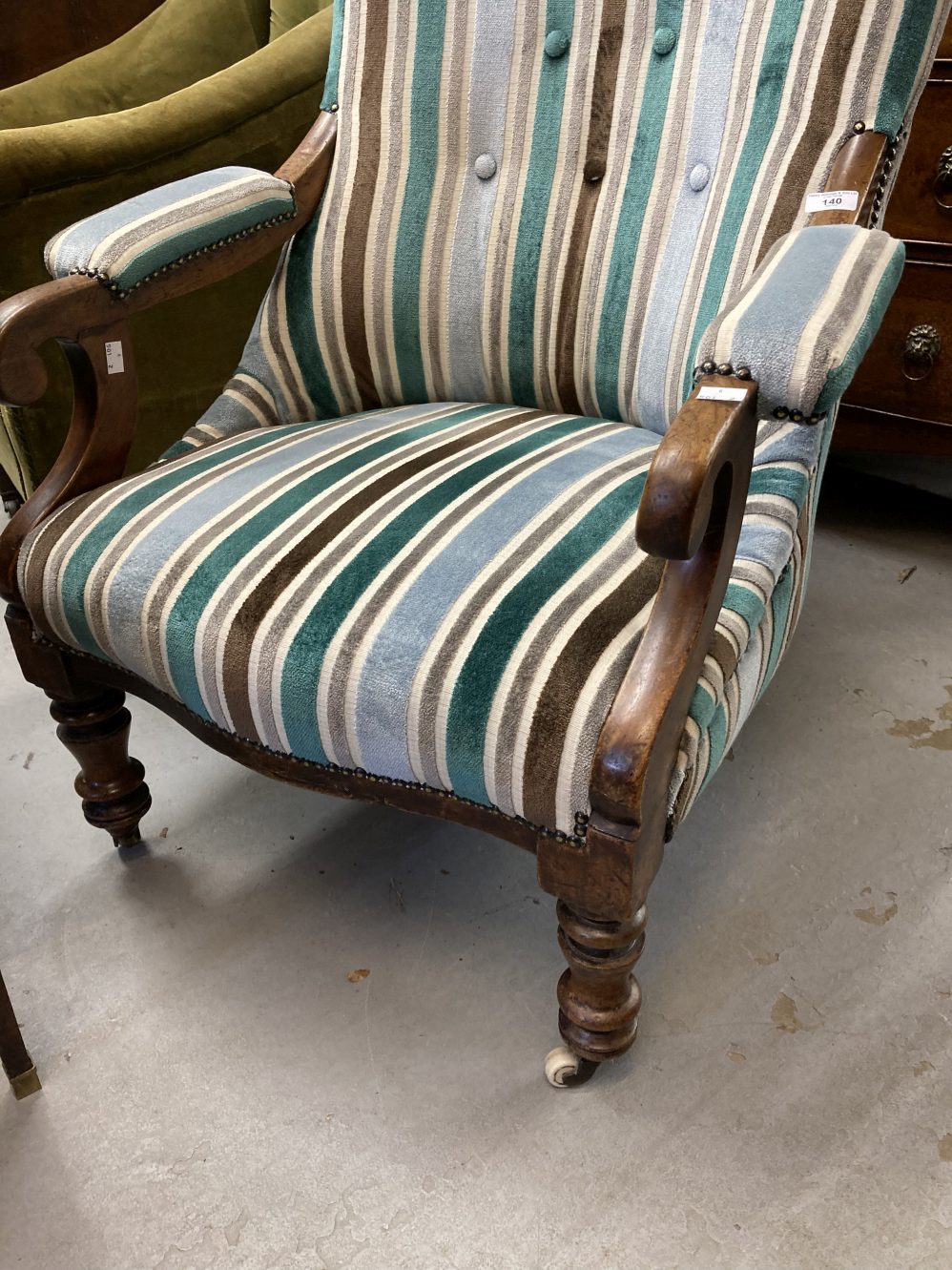 19th cent. Button back library armchair with scroll arms and turned legs on castors. 40ins. High. - Image 2 of 3