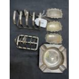 Hallmarked Silver: Ashtray, two toast racks, and three wine labels, various hallmarks. Total