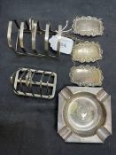 Hallmarked Silver: Ashtray, two toast racks, and three wine labels, various hallmarks. Total