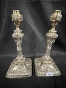 Pair of filled silver Adam style candelabra with ram's head festoon and classical urn decoration