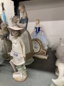 20th cent. Ceramics: Two Nao figurines, one of a girl with an umbrella and one of a woman cradling a