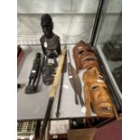 Tribal Artefacts: Includes ebony female bust, three wooden masks, a figure and four weapons.