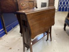 Edwardian arts and crafts mahogany drop flap table shaped top on slender supports.