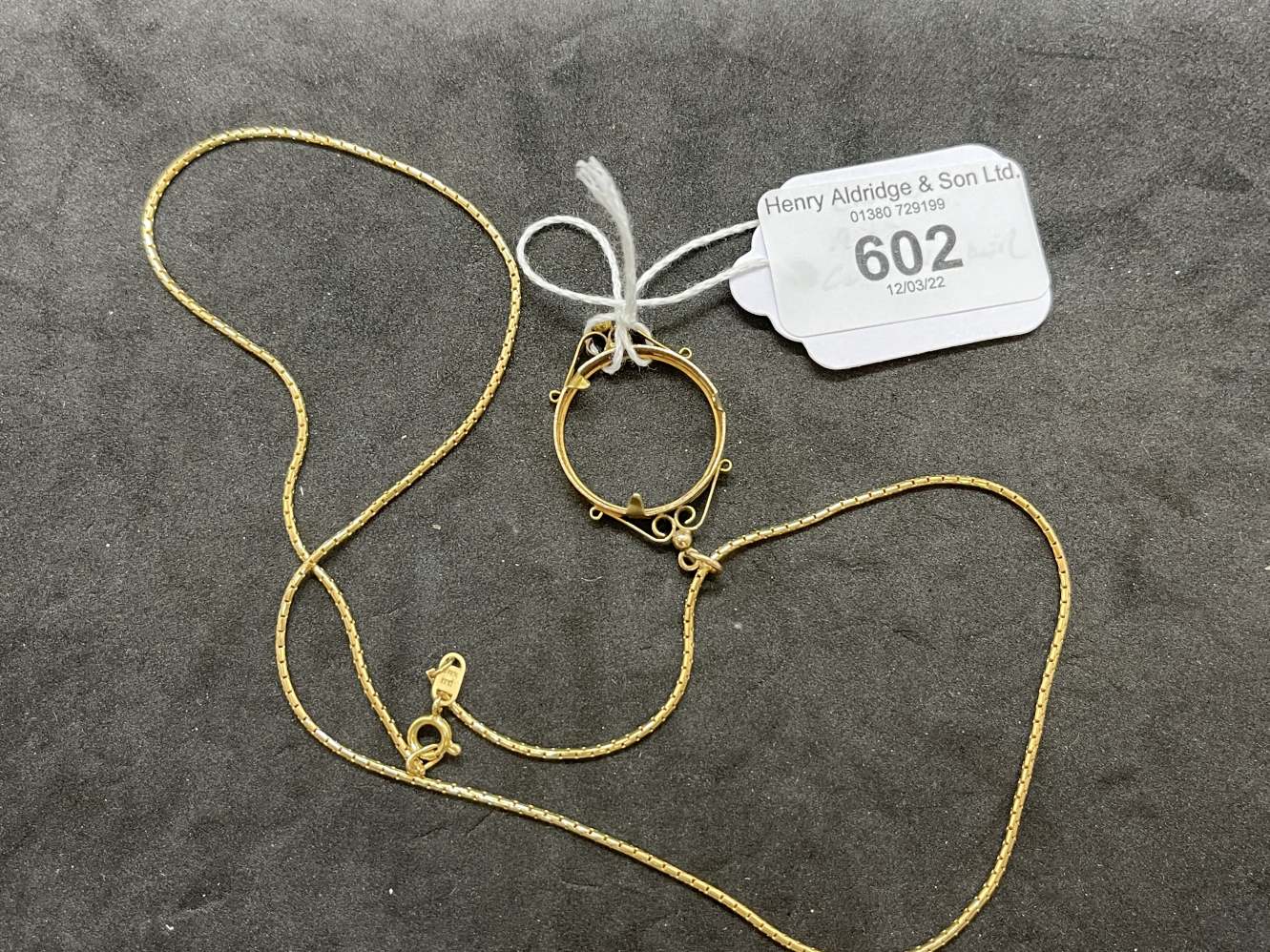 Jewellery: Yellow metal chain tests as 18ct gold, length 20ins. with a coin mount attached tests