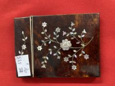 Tortoiseshell card case inlaid with mother of pearl in floral decoration.